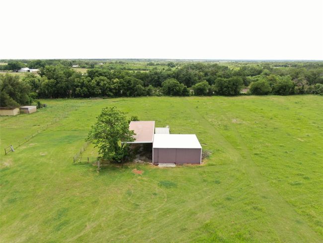 Aerial view of sparsely populated area featuring a pastoral area | Image 21