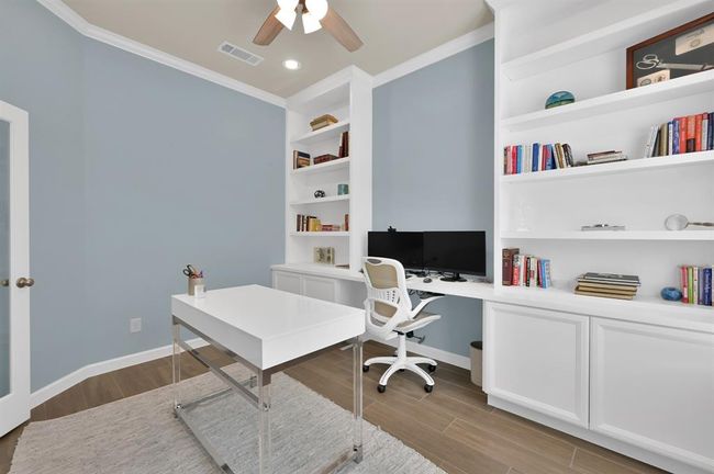 There is plenty of shelving and cabinetry for all of your office storage needs! Making this home office your own would be a SMART choice. | Image 6
