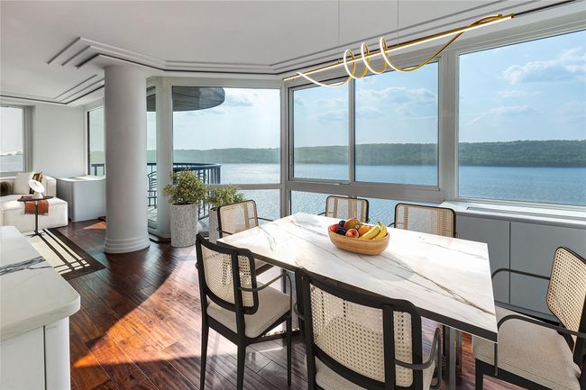 Sunroom featuring plenty of natural light and a water view | Image 7