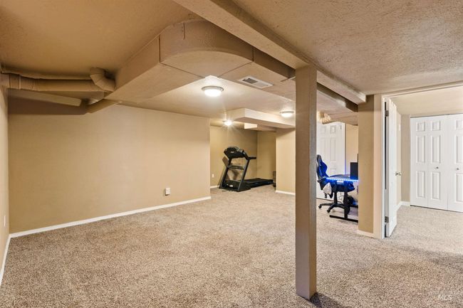 Workout area featuring a textured ceiling and light carpet | Image 31