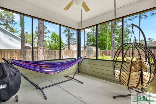Screened in back porch with ceiling fan to keep cool | Image 41