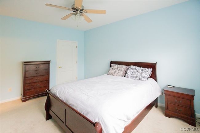 Bedroom featuring light colored carpet, baseboards, and a ceiling fan | Image 10