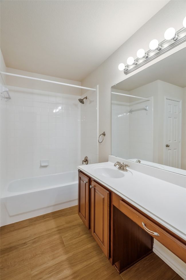 Bathroom featuring, oversized vanity with 1 sink, linen closet and combination tub/shower. | Image 19