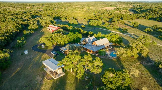 Aerial view of property's location featuring a heavily wooded area | Image 4