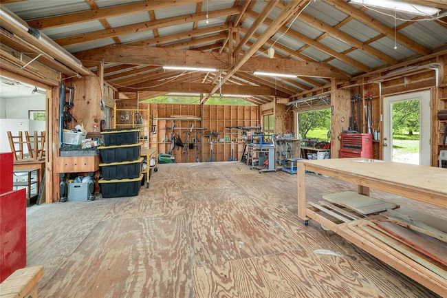 Miscellaneous room with lofted ceiling and a workshop area | Image 25