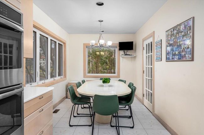 Dining area with a chandelier and baseboards | Image 7