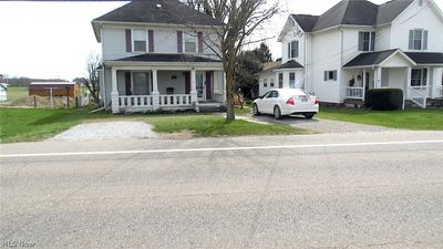 View of front of property with covered porch and a front lawn | Image 1