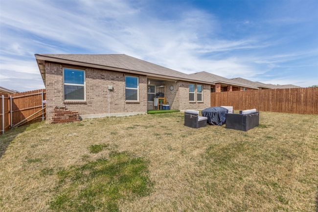 Back of property with a fenced backyard, brick siding, and a yard | Image 23