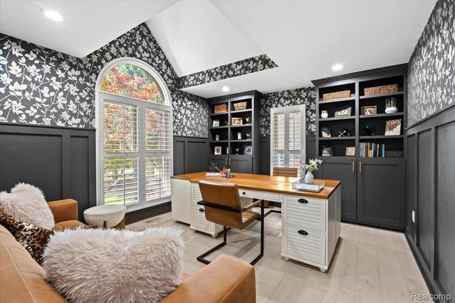 Study with built in cabinets and arched window. | Image 7