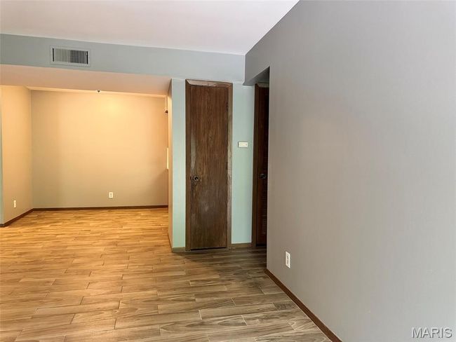 Empty room with light wood-type flooring | Image 9