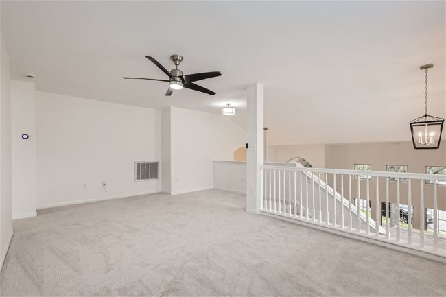 Spare room featuring a ceiling fan, carpet flooring, and baseboards | Image 35