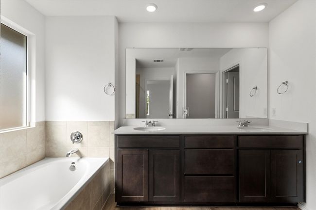 Full bath featuring a garden tub, double vanity, and recessed lighting | Image 15