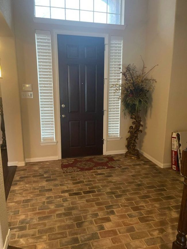 Foyer with plenty of natural light, brick floor, and baseboards | Image 6