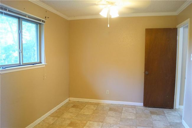 Unfurnished room featuring a ceiling fan and crown molding | Image 8