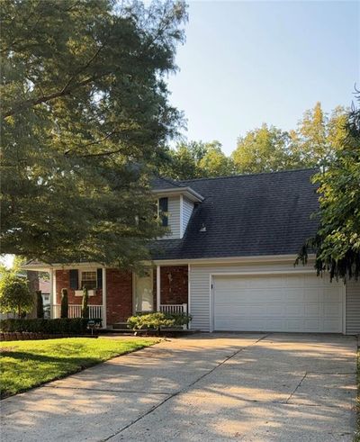 Cape cod house featuring a garage | Image 1