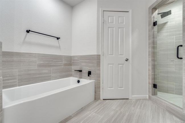 Full bath with a stall shower, a garden tub, and a textured wall | Image 5
