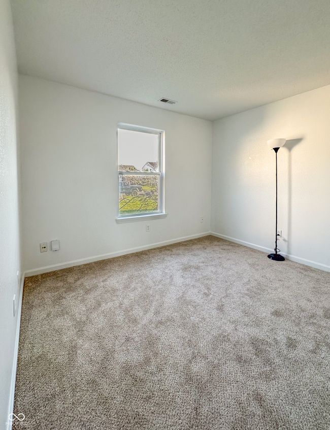 spare room featuring carpet, visible vents, and baseboards | Image 13