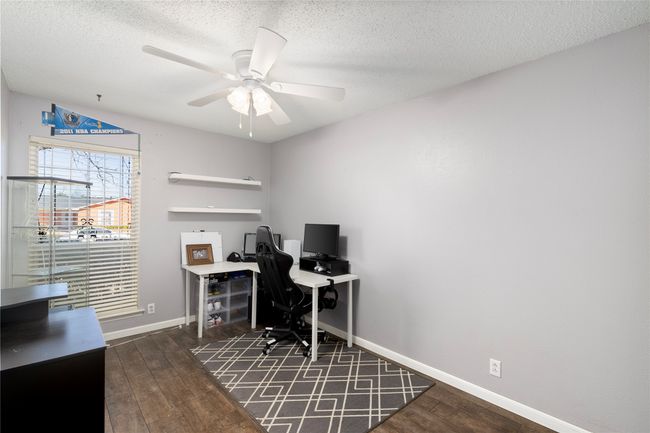 Office area featuring baseboards, a textured ceiling, and hardwood / wood-style floors | Image 17