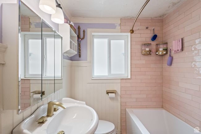 Full bath with crown molding, a wainscoted wall, a sink, and toilet | Image 11