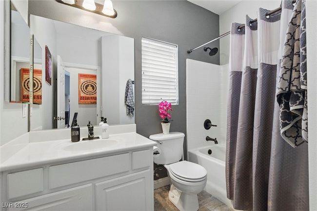 Full bath with toilet, vanity, and shower / bath combo with shower curtain | Image 27