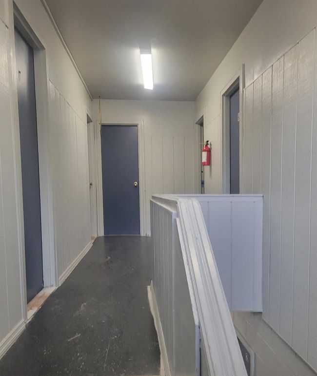 Hallway featuring unfinished concrete floors | Image 25