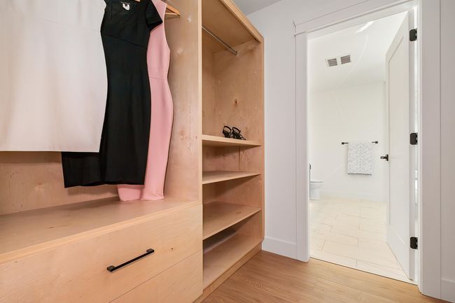 Spacious closet with light wood-style flooring | Image 21