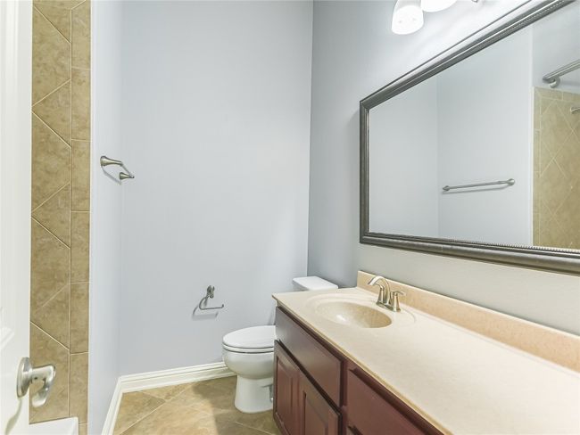 Another full bath is located by the two secondary bedrooms. | Image 20