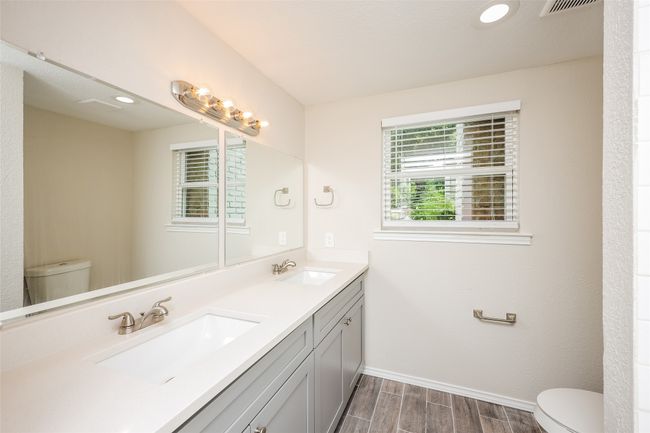 Bathroom featuring wood finished floors, double vanity, and recessed lighting | Image 15