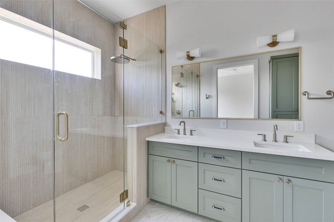Bathroom with a stall shower and double vanity | Image 29