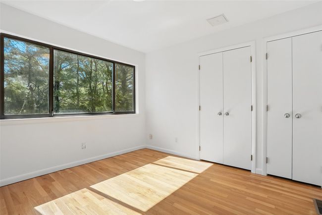 Bedroom with expansive windows and two double closets. | Image 27
