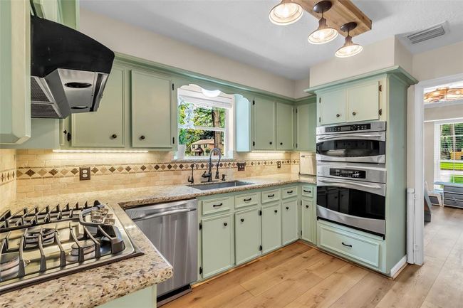 Upgraded stainless-steal appliances and custom lighting fixture. | Image 20