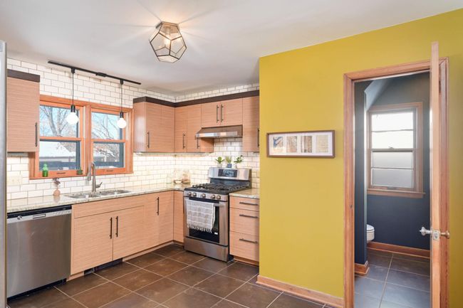 The main floor powder room is located just off the kitchen. | Image 16