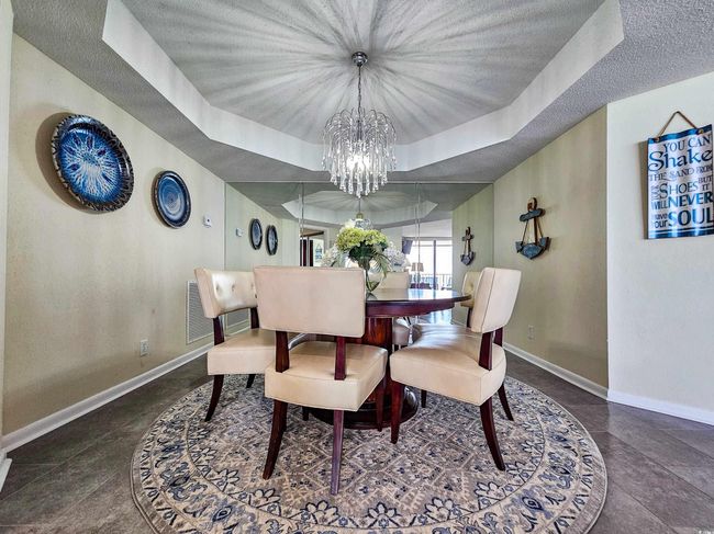 Dining area featuring a chandelier, a tray ceiling, and a textured ceiling | Image 14
