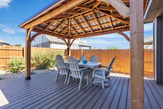 Deck featuring outdoor dining space, a fenced backyard, and a gazebo | Image 21