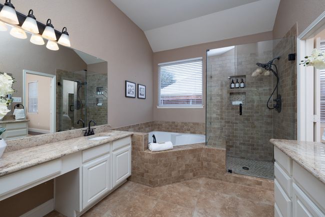 Bathroom with vaulted ceiling, vanity, a stall shower, and a garden tub | Image 19