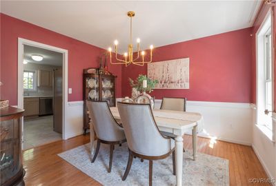 Dining area featuring an inviting chandelier, sink, and light wood-type flooring | Image 3