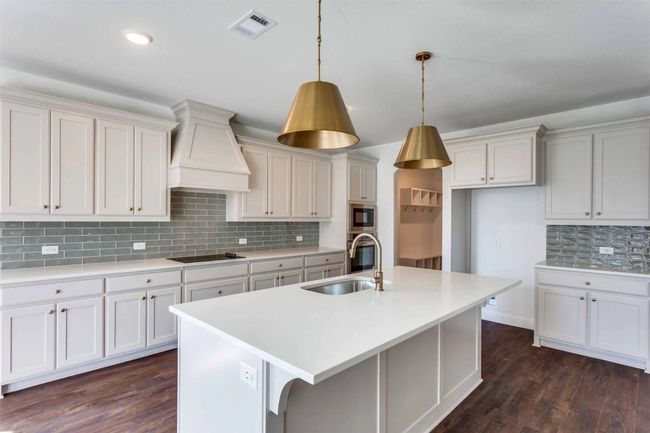 Kitchen featuring tasteful backsplash, sink, dark hardwood / wood-style floors, and custom exhaust hood | Image 7