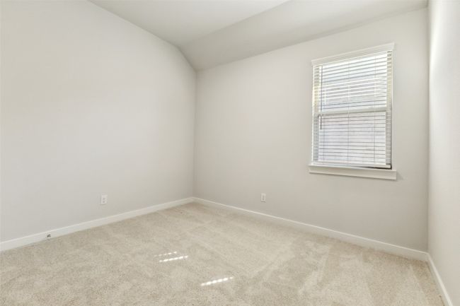 Unfurnished room with light carpet, baseboards, and lofted ceiling | Image 16