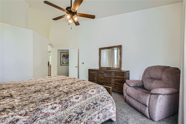 Carpeted bedroom featuring arched walkways and ceiling fan | Image 24
