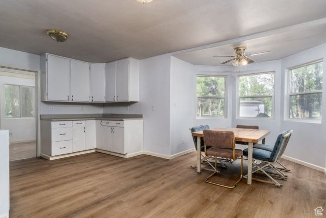 Dining room featuring light wood-style floors and ceiling fan | Image 19