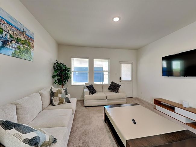 Living area with light colored carpet, plenty of natural light, and recessed lighting | Image 8