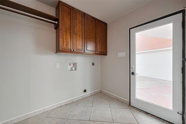 Laudry room space, with half bath also located here. Real, wood cabinets for extra storage. Door takes you to the breezeway and the detached garage. | Image 22