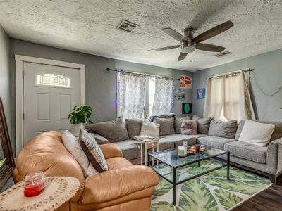 Living room featuring ceiling fan, hardwood / wood-style floors, and a textured ceiling | Image 2