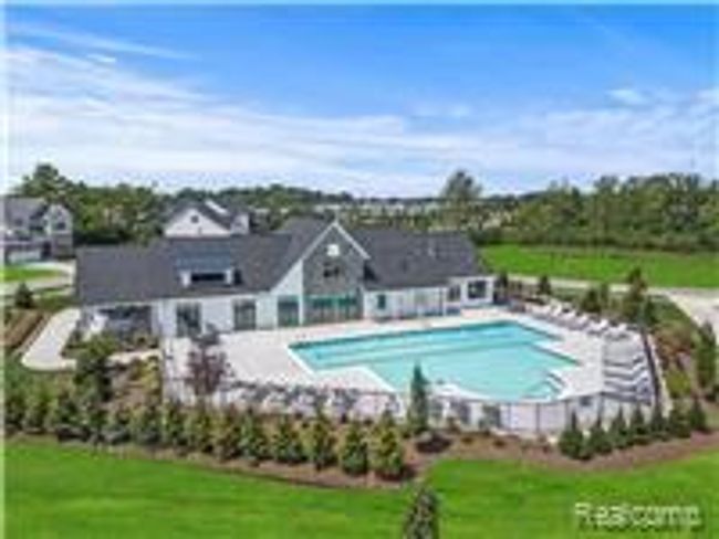 Community pool with a lawn and a patio | Image 15