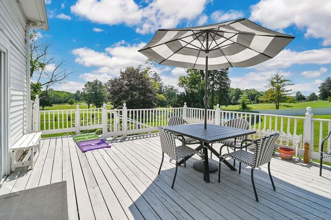 Deck with pool and golf course views | Image 18