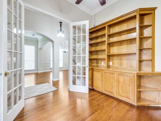 Desirable home office featuring double doors, hardwood floors, and a custom build int. | Image 6
