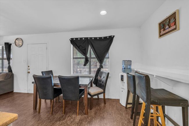 Dining space featuring dark wood-type flooring and healthy amount of natural light | Image 6