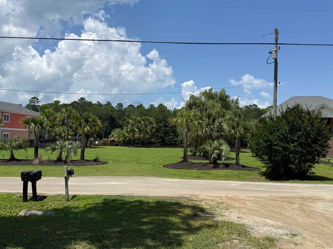View of property's community featuring a yard | Image 16