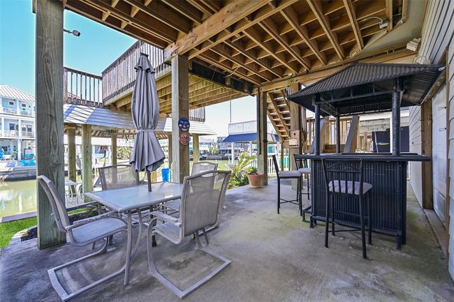Spacious lower patio with abundant seating for relaxation and entertainment. | Image 30