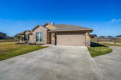 Home features 2 car garage & landscaping. | Image 2